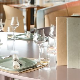 Elegant place setting with menus and wine glasses.