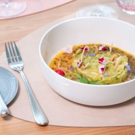 Avocado and passion fruit tartare served in an elegant bowl.