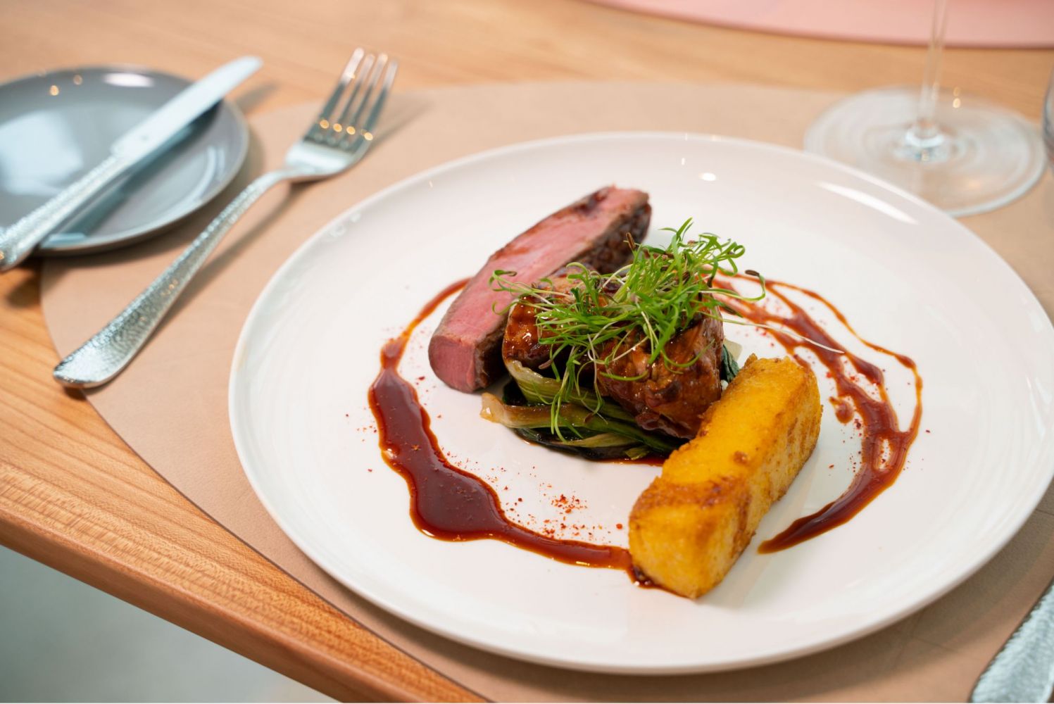 Exclusively served fillet of beef including garnish on a fine place setting.