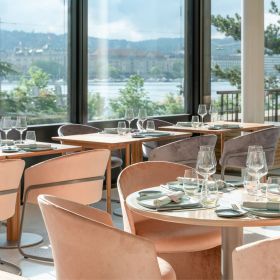 Elegantly furnished restaurant with an exclusive ambience and lake view.